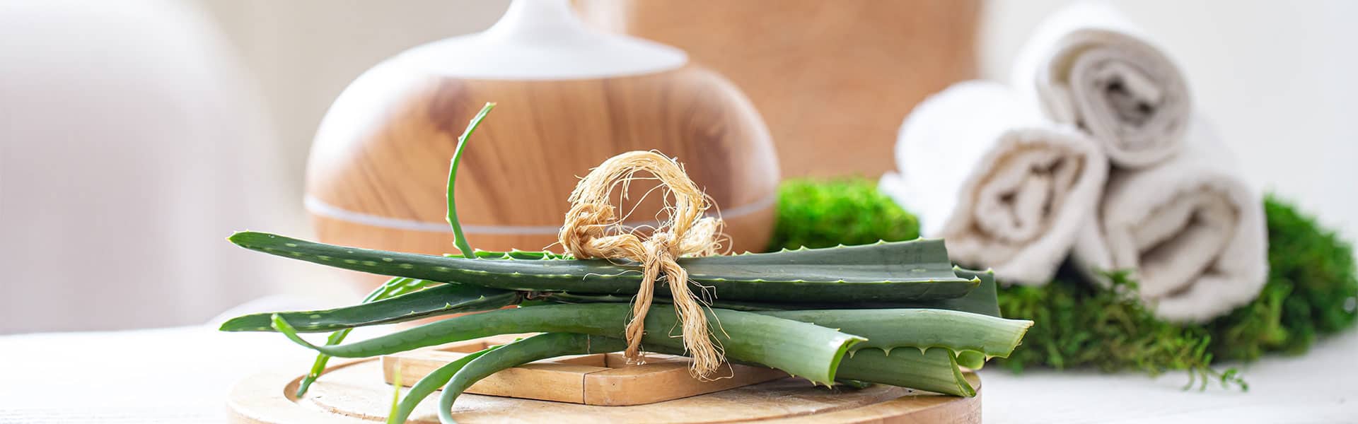 Blumen, Spa- und Wellnesszubehör für Escort Service Damen auf einer Holztisch. Ruhige Atmosphäre, entspannender Raum, Massagezubehör.